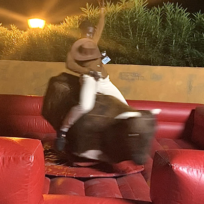 Student riding mechanical bull at conference event